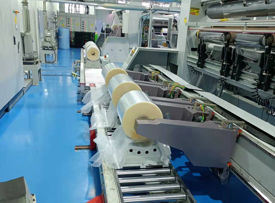 How do secondary slitters cut thick or layered materials differently from regular slitters?